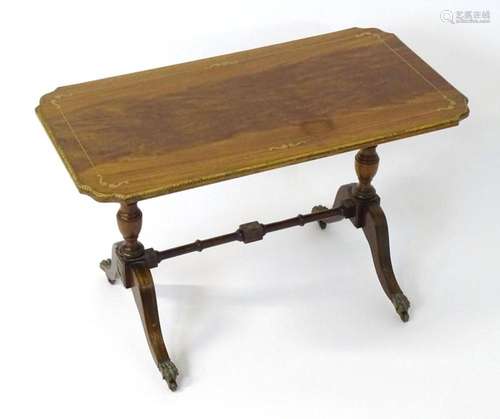 A mid 20thC mahogany coffee table with inlaid brass work dec...