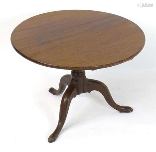 A late 18thC mahogany tripod tilt top table with a circular ...