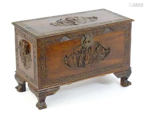 An early 20thC Chinese camphor wood trunk, having a figural ...