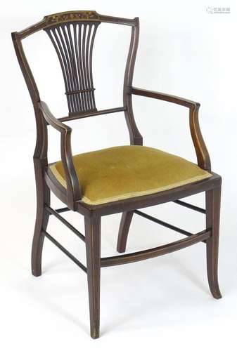 An Edwardian open armchair / elbow chair, having a shaped to...