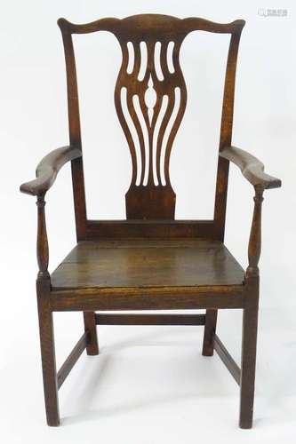 A late 18thC ash and elm Chippendale elbow chair with a shap...