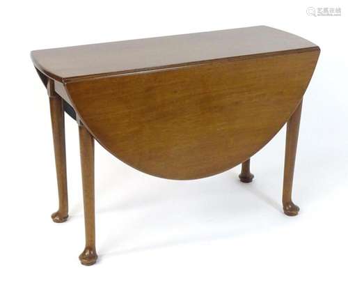 A late 19thC mahogany drop leaf table, having two demi lune ...