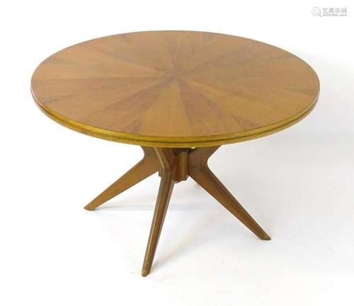 Vintage / Retro: A circular coffee table with a sun burst st...