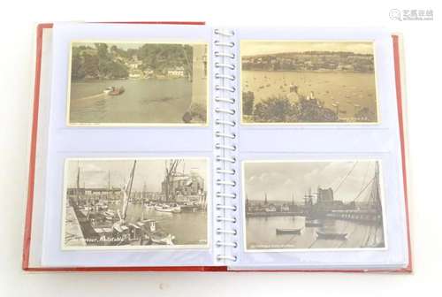 A 20thC postcard album containing various postcards to inclu...