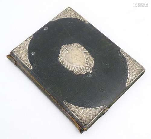 An early 20thC green leather blotter with embossed silver mo...