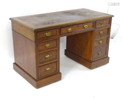 A late 19thC walnut double pedestal desk, the desk having a ...
