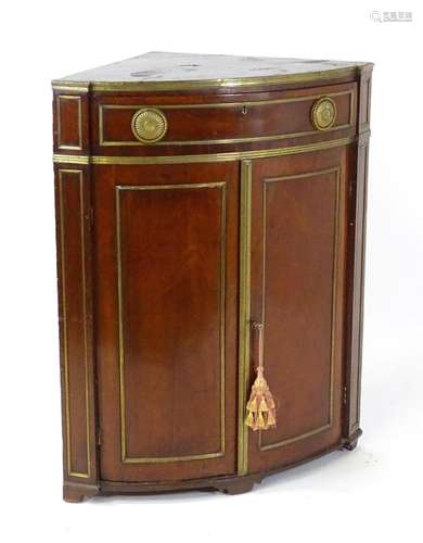 An early 19thC Russian corner cupboard of mahogany and brass...