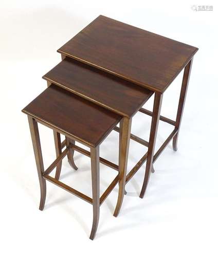 An early / mid 20thC mahogany nest of tables, the three grad...