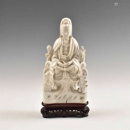 A CHINESE GUANYIN STATUE WITH STAND