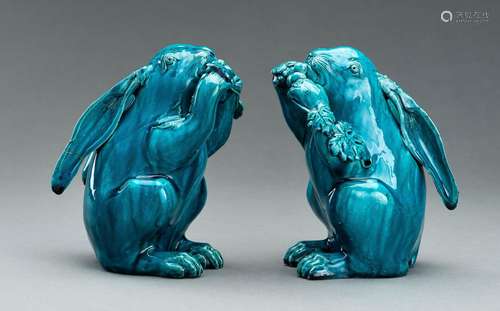 A PAIR OF TURQUOISE GLAZED CERAMIC FIGURES OF RABBITS EATING...