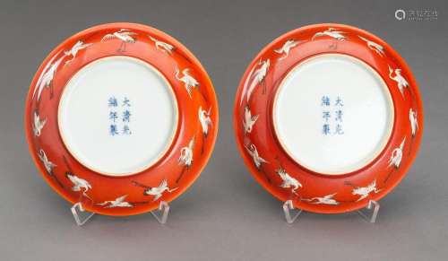 A PAIR OF RED GROUND \'BATS AND CRANES\' PORCELAIN SAUCER DI...