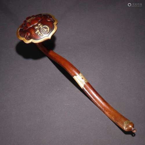 A gilt copper handle with the word "Fu"