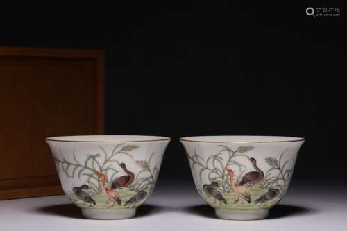 A pair of pastel cups with reeds and wild geese