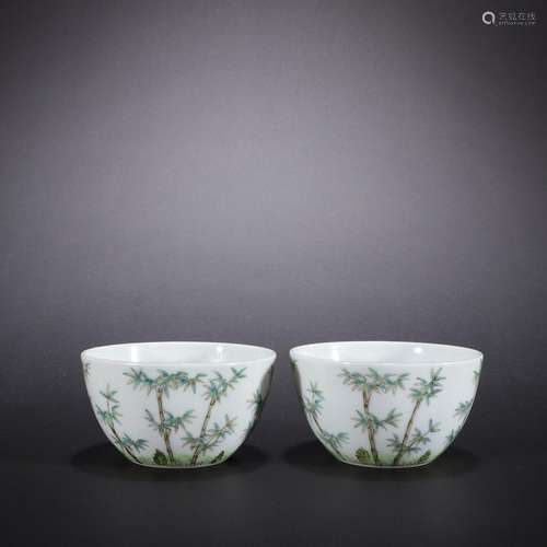 A pair of teacups with green bamboo pattern