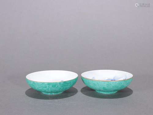 A pair of blue-and-white landscape cups with engraved celado...