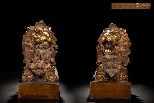 A pair of precision-cast gilt-copper pair of lion study orna...