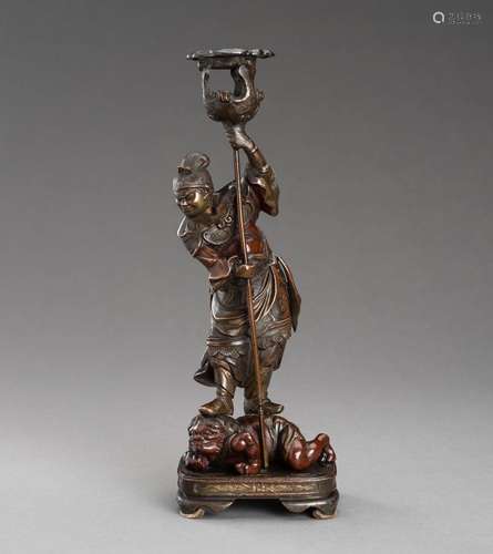 A METAL CANDLE STICK OF BISHAMONTEN ON A DEVIL, MEIJI