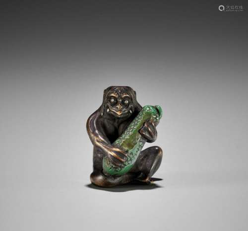 JUGYOKU: A RARE WOOD AND STAG ANTLER NETSUKE OF A KAPPA PLAY...