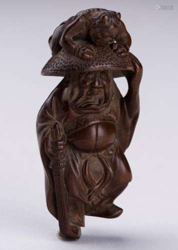 A BOXWOOD NETSUKE OF SHOKI AND ONI