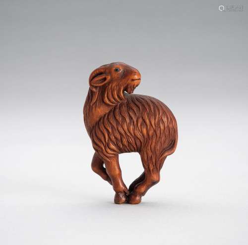 A WOOD NETSUKE OF A GOAT