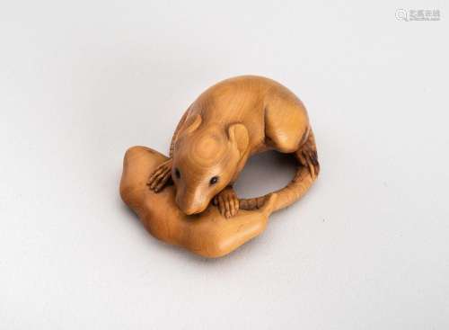 A WOOD NETSUKE OF A RAT WITH EDAMAME BEAN POD