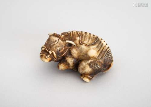 A STAG ANTLER NETSUKE OF RECUMBENT OX