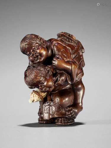 SEIHO: A FINE STAINED BOXWOOD NETSUKE OF CHILDREN AT PLAY