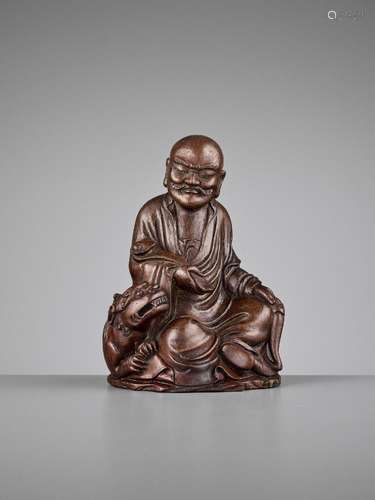 A BAMBOO FIGURE OF A LUOHAN AND BUDDHIST LION, QING