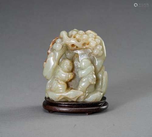 † A SMALL PALE CELADON AND RUSSET JADE BOULDER, 1930s