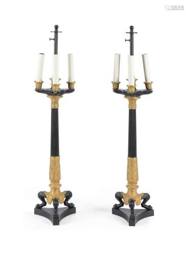 A PAIR OF LARGE PATINATED AND GILT METAL TABLE LAMPS IN EMPI...
