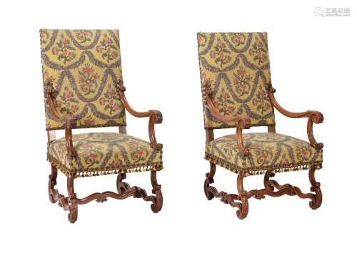 A PAIR OF CARVED WALNUT AND UPHOLSTERED OPEN ARMCHAIRS IN LO...