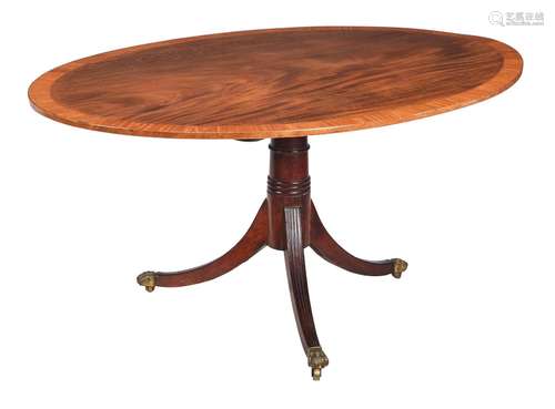 A REGENCY MAHOGANY AND SATINWOOD CROSSBANDED OVAL CENTRE TAB...