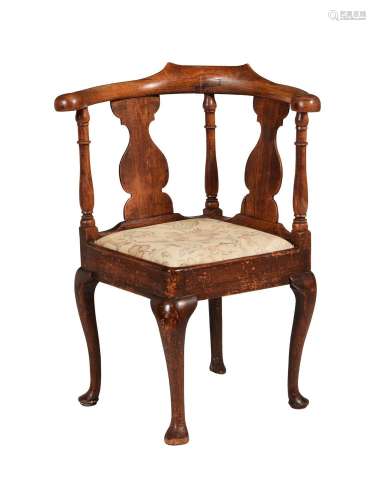 A GEORGE III WALNUT CORNER ARMCHAIR