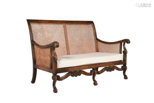 A CARVED BEECH BERGERE SETTEE IN LATE 17TH CENTURY STYLE