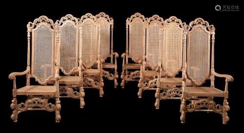 A SET OF EIGHT CARVED BEECH ARMCHAIRS IN CAROLEAN STYLE