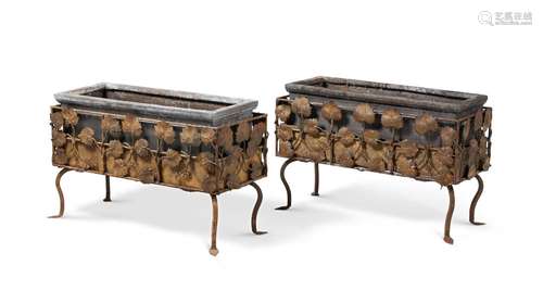 A PAIR OF ARTS AND CRAFTS WROUGHT IRON PLANTERS OR JARDINIER...