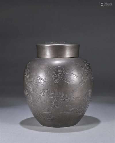 A landscape patterned tin jar
