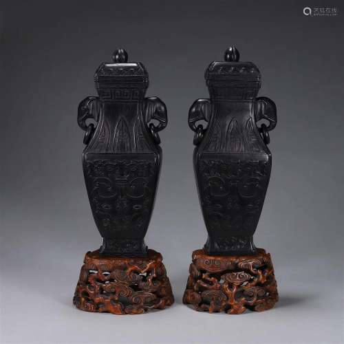 A pair of taotie patterned red sandalwood vases with elephan...