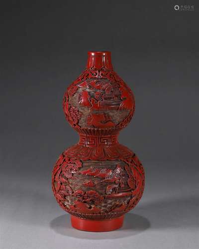 A landscape carved red lacquer gourd