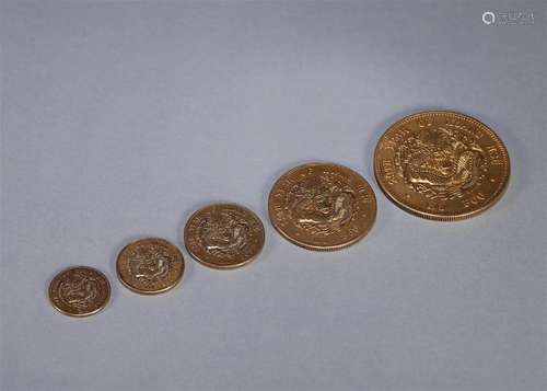 A set of 5 dragon patterned gold coins