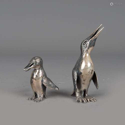 Two silver penguines