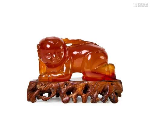 A HIGHLY RARE CHINESE SUZHOU AGATE FIGURE OF A YOUNG BOY, QI...