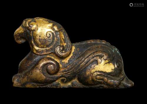A CHINESE GILT BRONZE WEIGHT IN THE SHAPE OF A MYTHICAL BEAS...