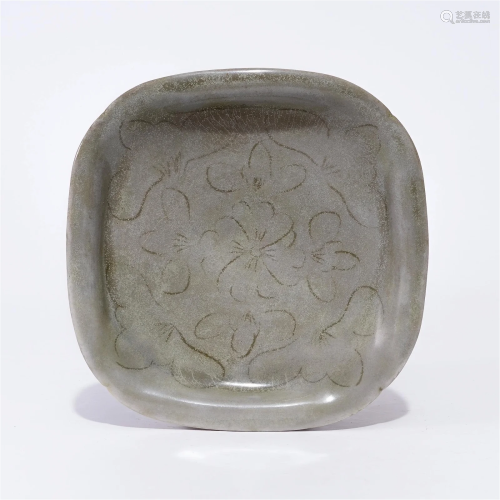 A Yue ware plate with carved design in the Tang Dynasty