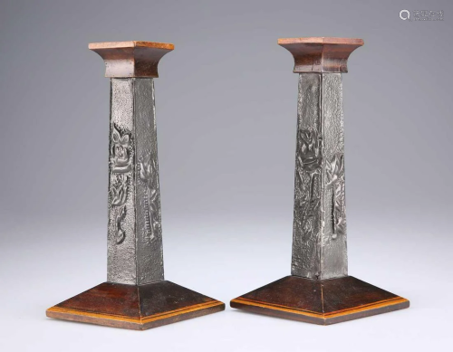 A PAIR OF ARTS AND CRAFTS PEWTER-MOUNTED WOODEN CANDLESTICKS