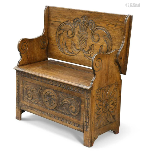 AN EARLY 20TH CENTURY CARVED OAK MONK'S BENCH