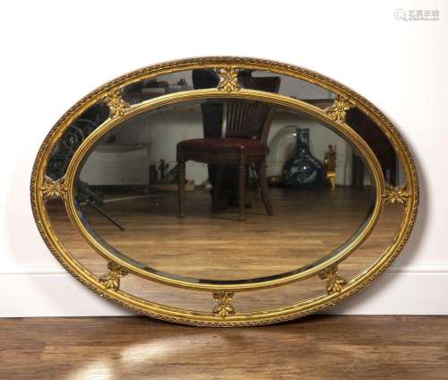 Oval gilt plaster wall mirror 19th Century, with ribbon bord...