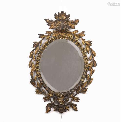 Gilt metal oval wall mirror late 19th Century, with mask and...