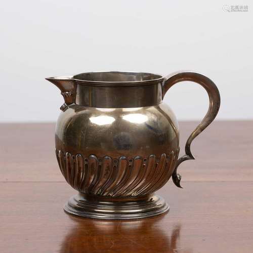 Victorian silver jug with trophy handle on circular base, be...