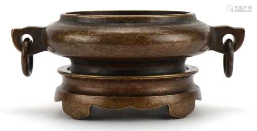 Chinese patinated bronze twin handled censer on stand, four ...